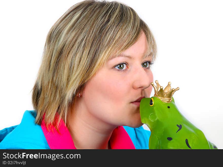 Young woman kissing a frog prince on white background. Shot in studio.