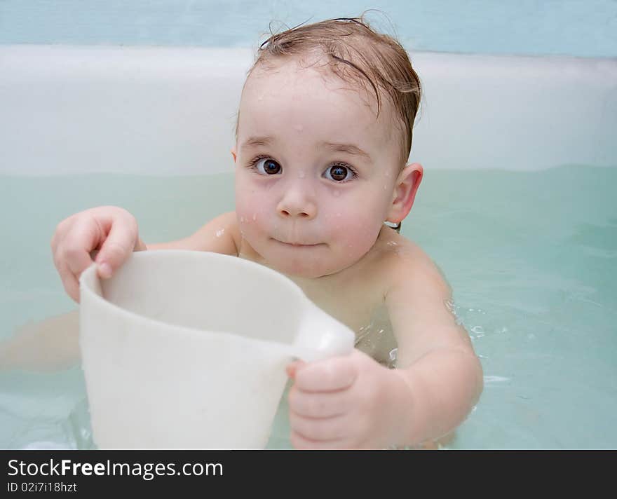 Baby is taking the bath. Baby is taking the bath