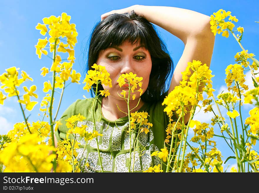 Girl looking closely at a yellow flower. Girl looking closely at a yellow flower