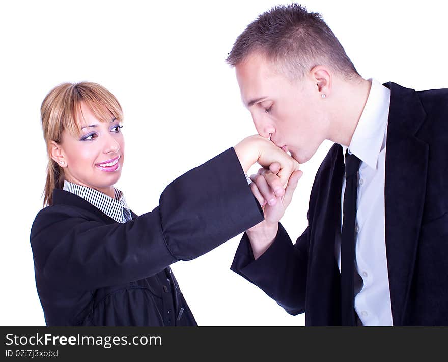 Handsome businessman kisses lady's hand , studio shot