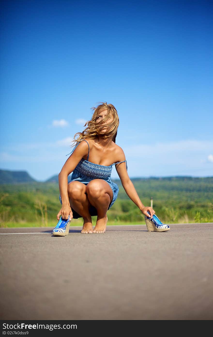 Beautiful fashion female model with blond and curly feeling a hot summer day. Beautiful fashion female model with blond and curly feeling a hot summer day