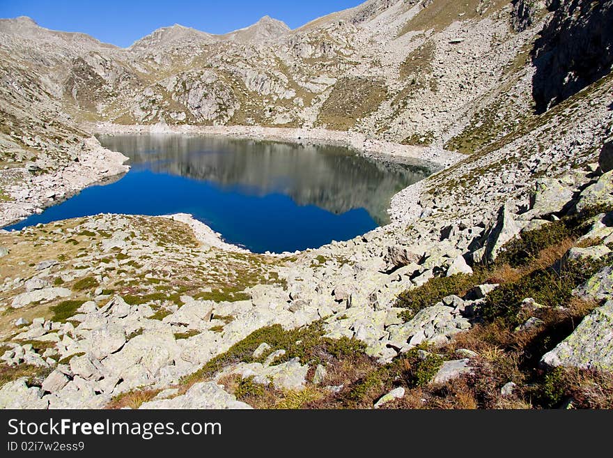 Sunny day, blue sky, mountain lake in Aiguestortes National Park. Sunny day, blue sky, mountain lake in Aiguestortes National Park.