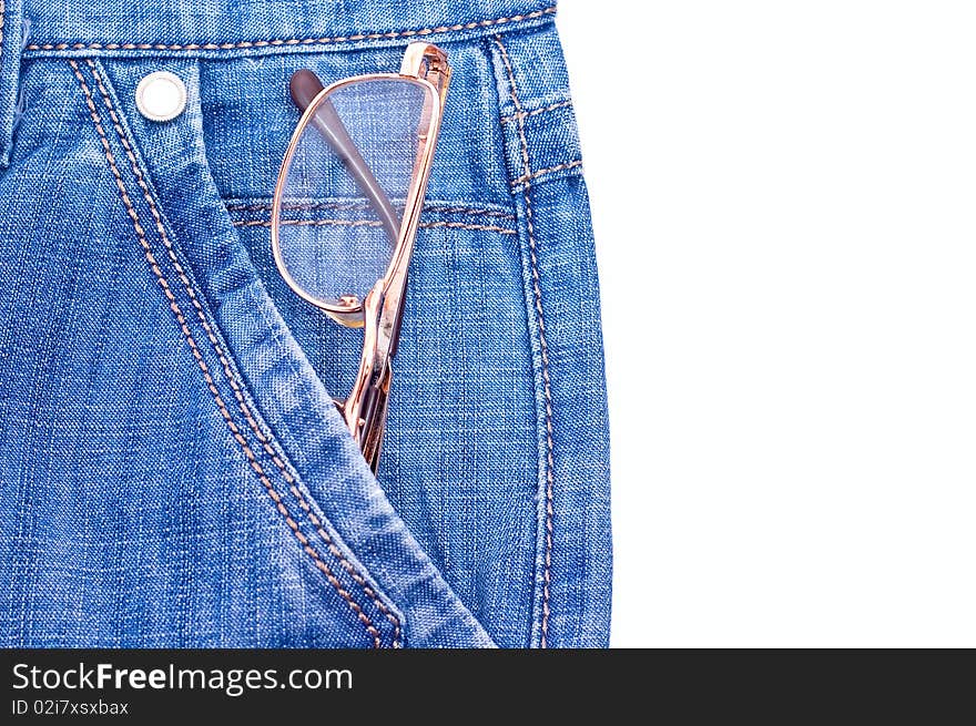 Old gold glasses in blue jeans pocket. Isolated on white