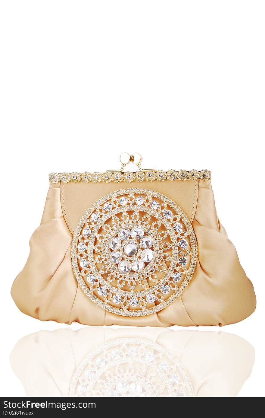 This is a beautiful ladies fancy golden clutch purse isolated on a white background.