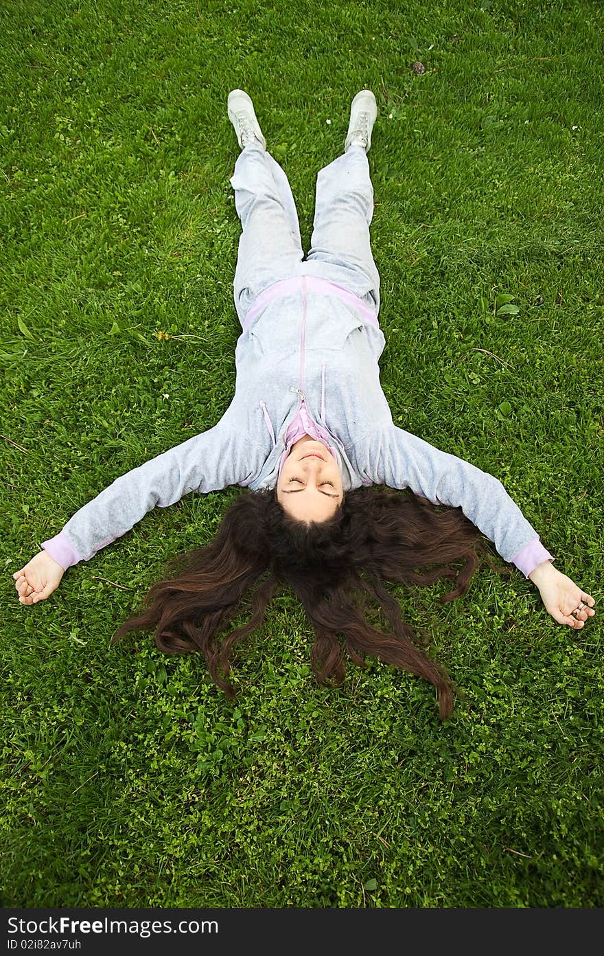 Girl Lying upside down on fresh grass