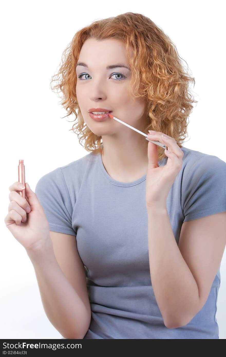 Blond woman applying make up