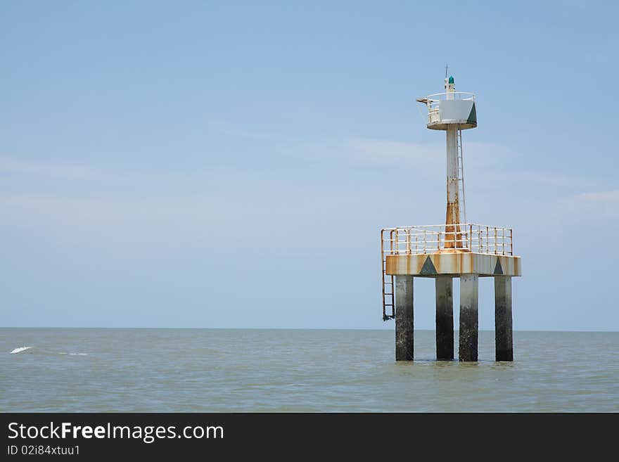 A small light tower with blue sky in the background.