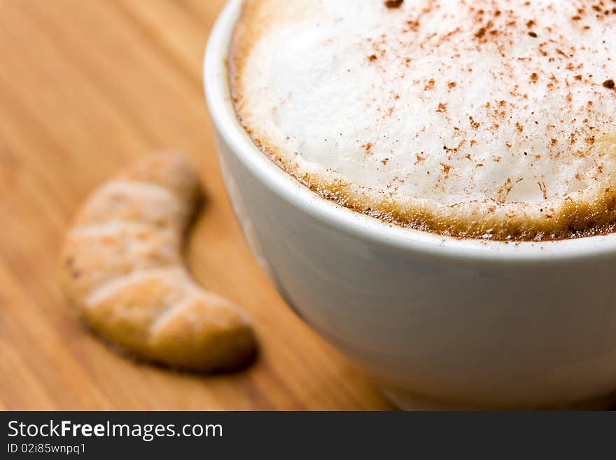 Cappuccino and Sweet Cookies on the wooden Background .