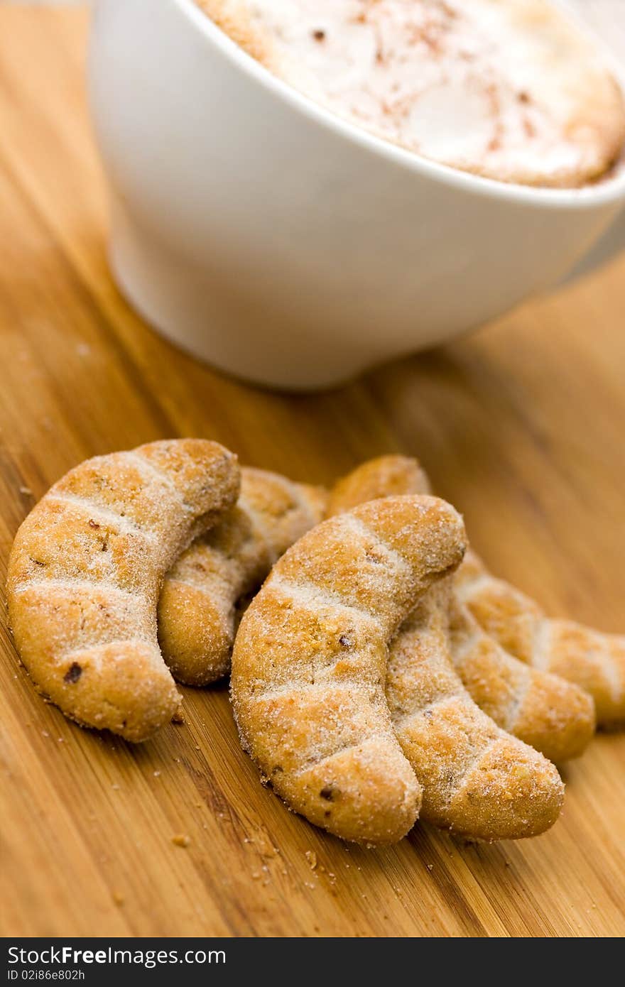 Cappuccino and Sweet Cookies on the wooden Backgro