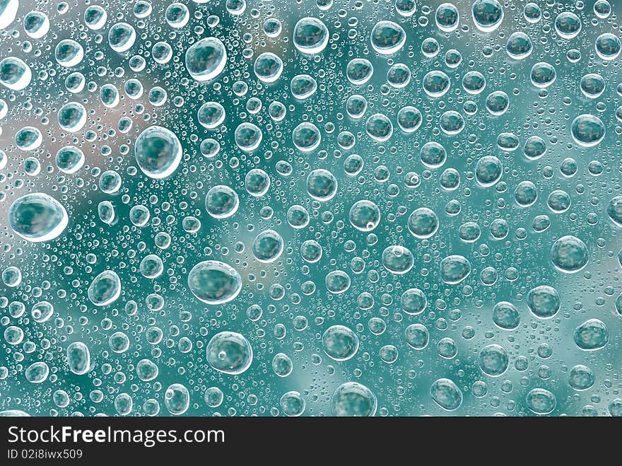 Water bubbles on a green glass. Abstract background