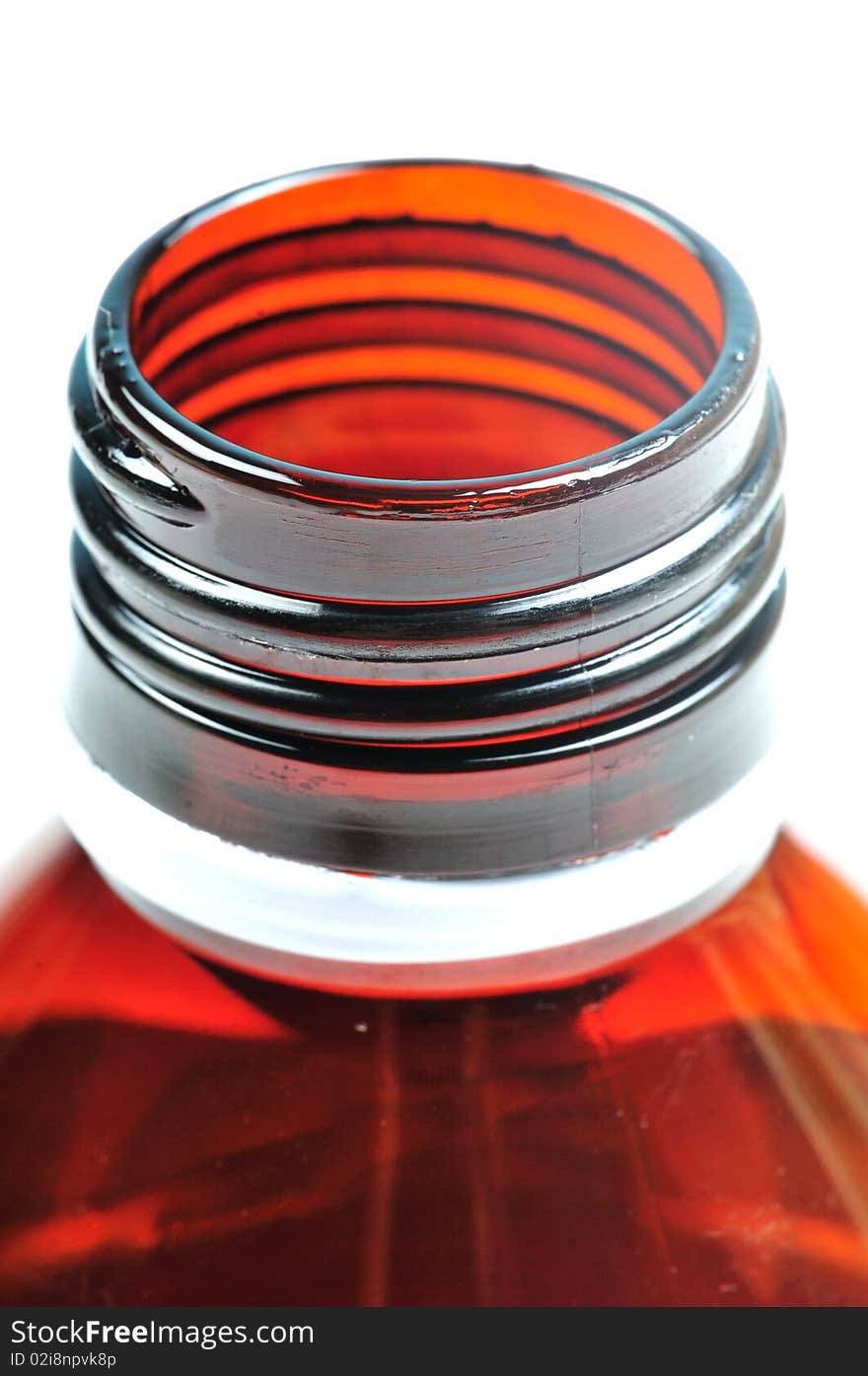 Macro shot of bottle mouth over white background.