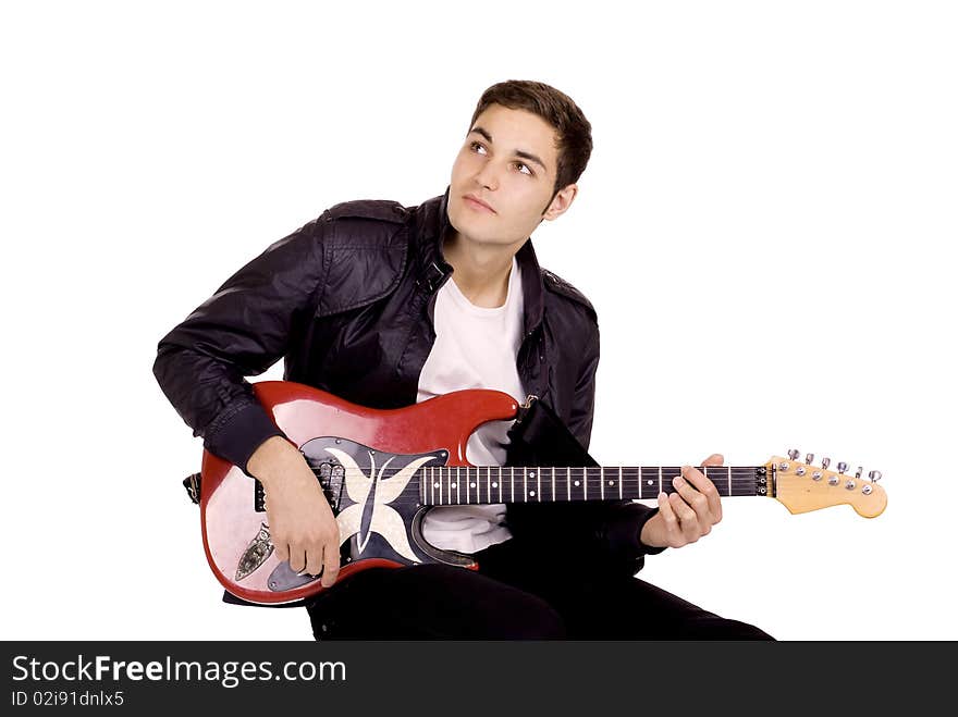 Young male guitarist playing on a red guitar. Young male guitarist playing on a red guitar