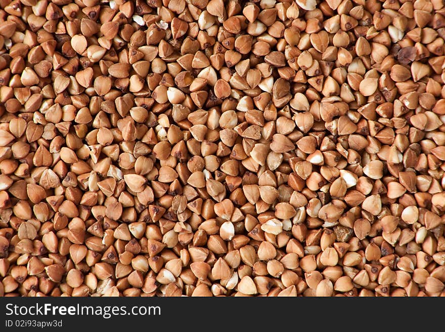 Background of dry raw buckwheat. Background of dry raw buckwheat