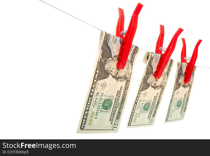 A line of three twenty dollar bills on a line as if they are drying. The bills are attached to the line with red clothes pegs. Studio isolated with an accurate clipping path. A line of three twenty dollar bills on a line as if they are drying. The bills are attached to the line with red clothes pegs. Studio isolated with an accurate clipping path.