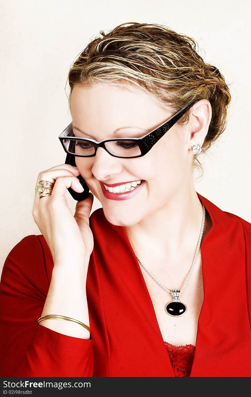 Friendly business woman in red suit on the telephone. Friendly business woman in red suit on the telephone