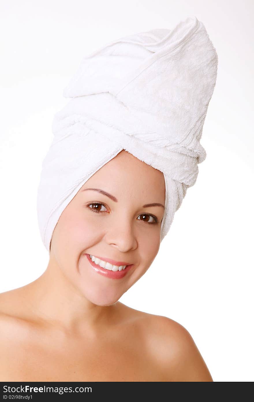 Young woman face with a towel in her head. Concept: freshness, shower and spa. Young woman face with a towel in her head. Concept: freshness, shower and spa