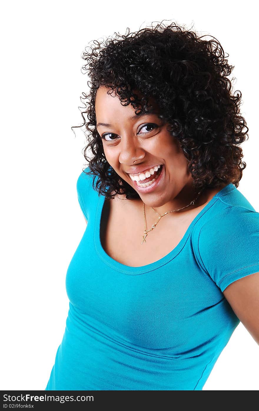 A portrait of a young Hispanic woman with curly black hair an blue top with a big smile on her face, standing in the studio for white background. A portrait of a young Hispanic woman with curly black hair an blue top with a big smile on her face, standing in the studio for white background.