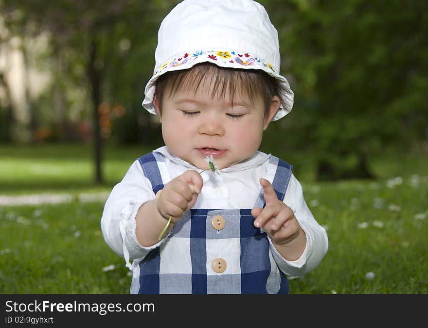 Cute little girl with flower in garden