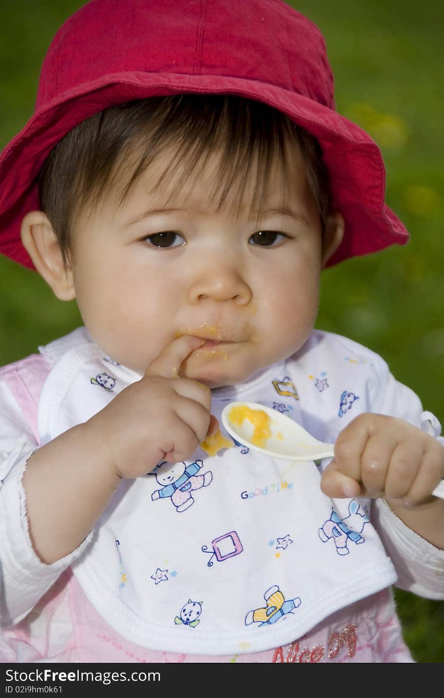 Cute little girl eatting in garden