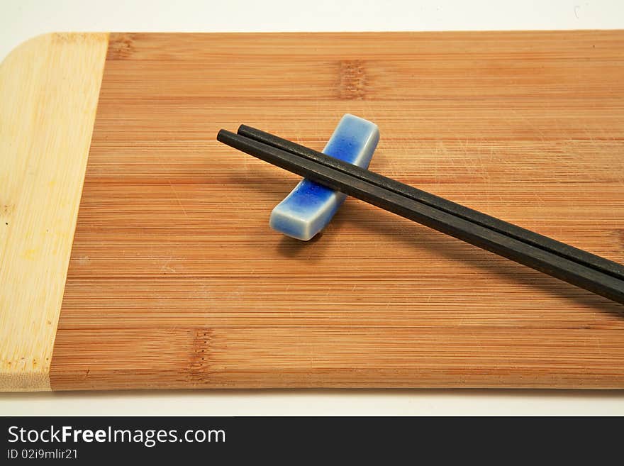 Close up of chopsticks on bamboo cutting board