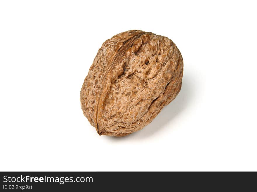 A raw walnut against white background