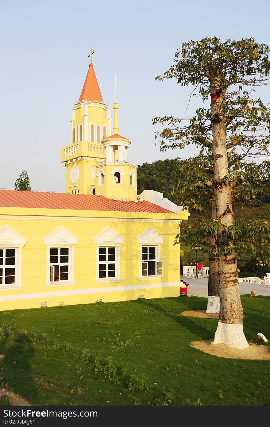 A yellow church.In the garden.Colorful.