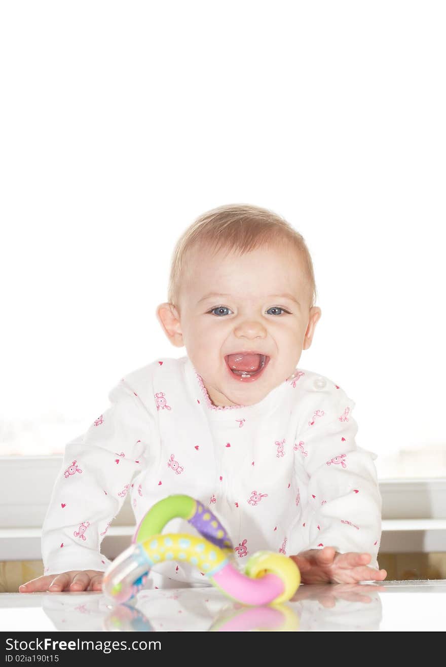 Portrait of the newborn child with a toy in a hand. Portrait of the newborn child with a toy in a hand