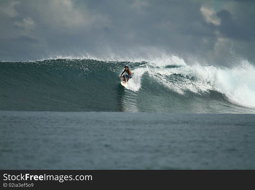 Surfer on wave, Mentawai Islands, Indonesia