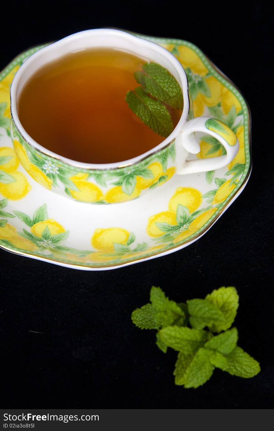 Cup of tea on black background