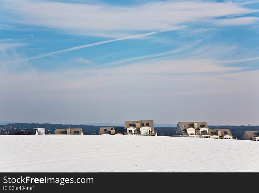 Landscape With Housing Area In Snow And Blue Sky