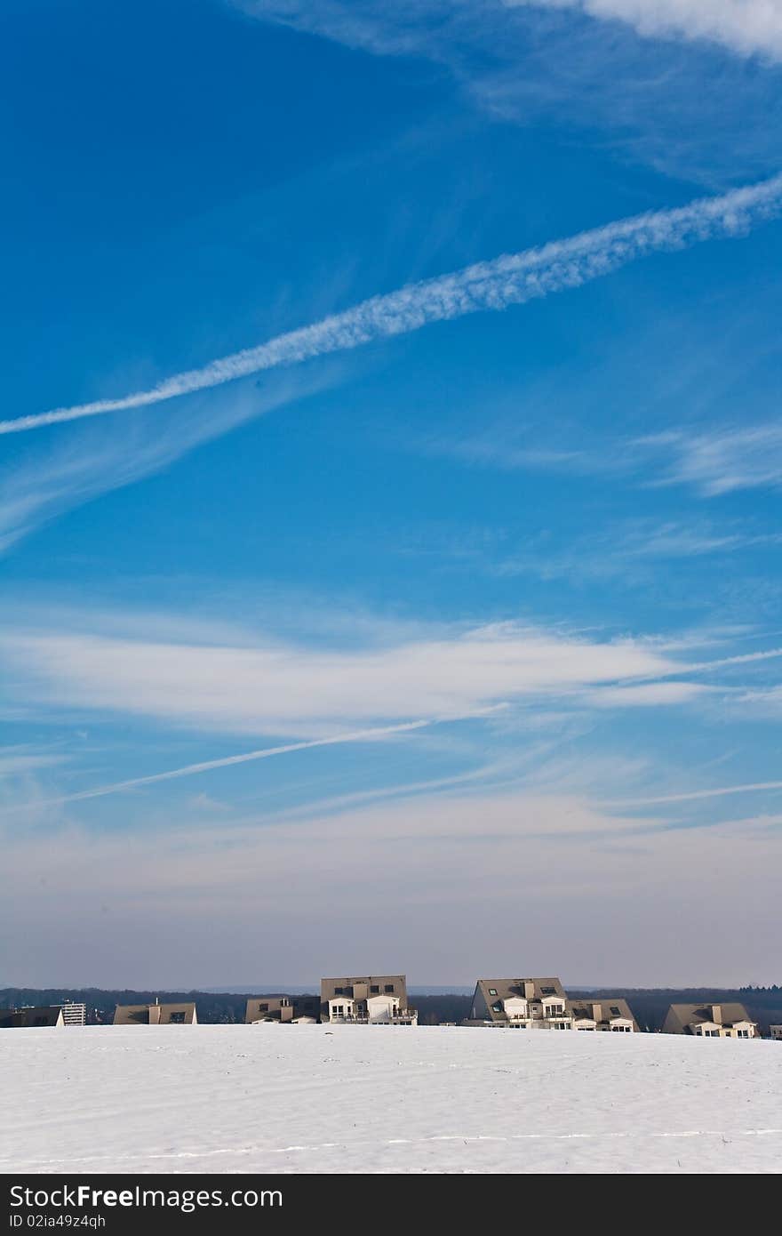 Landscape With  Housing Area In Snow And Blue Sky