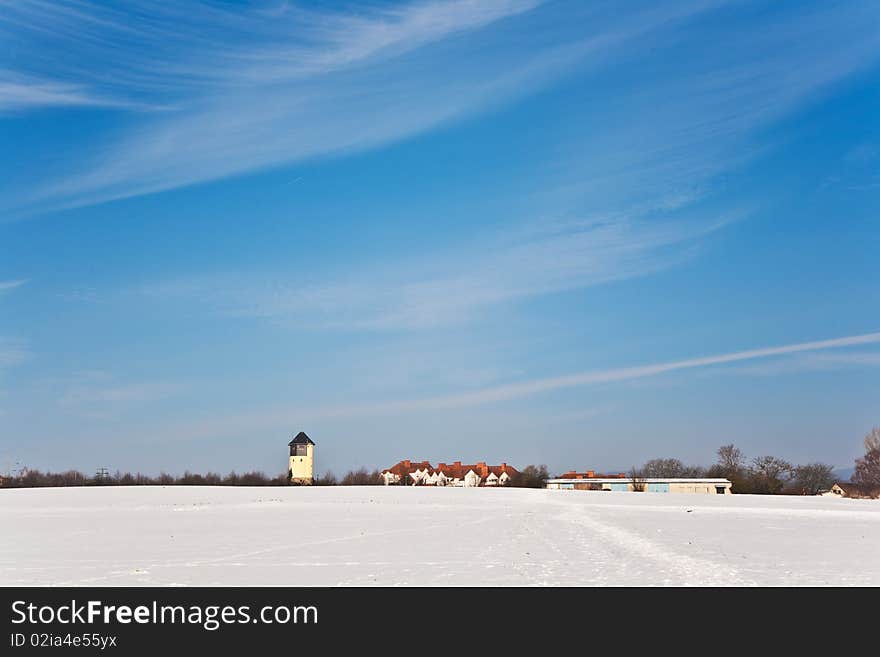 Landscape with water tower in snow