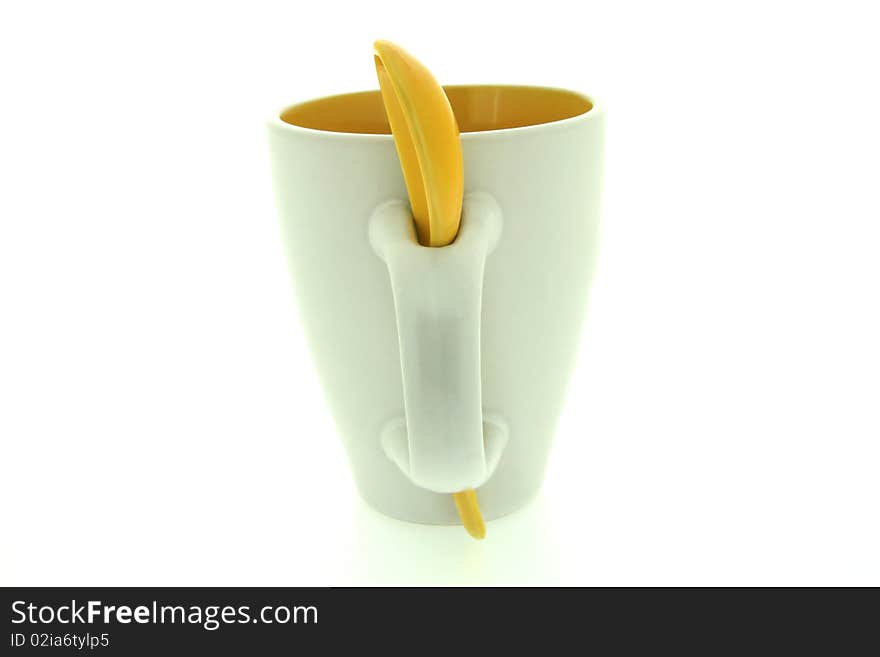 White mug and yellow spoon