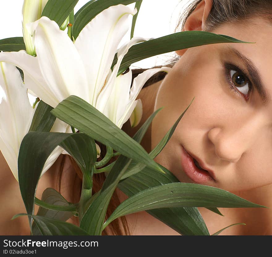 Portrait of a young and attractive brunette with a white flower Image isolated on a white background. Portrait of a young and attractive brunette with a white flower Image isolated on a white background.