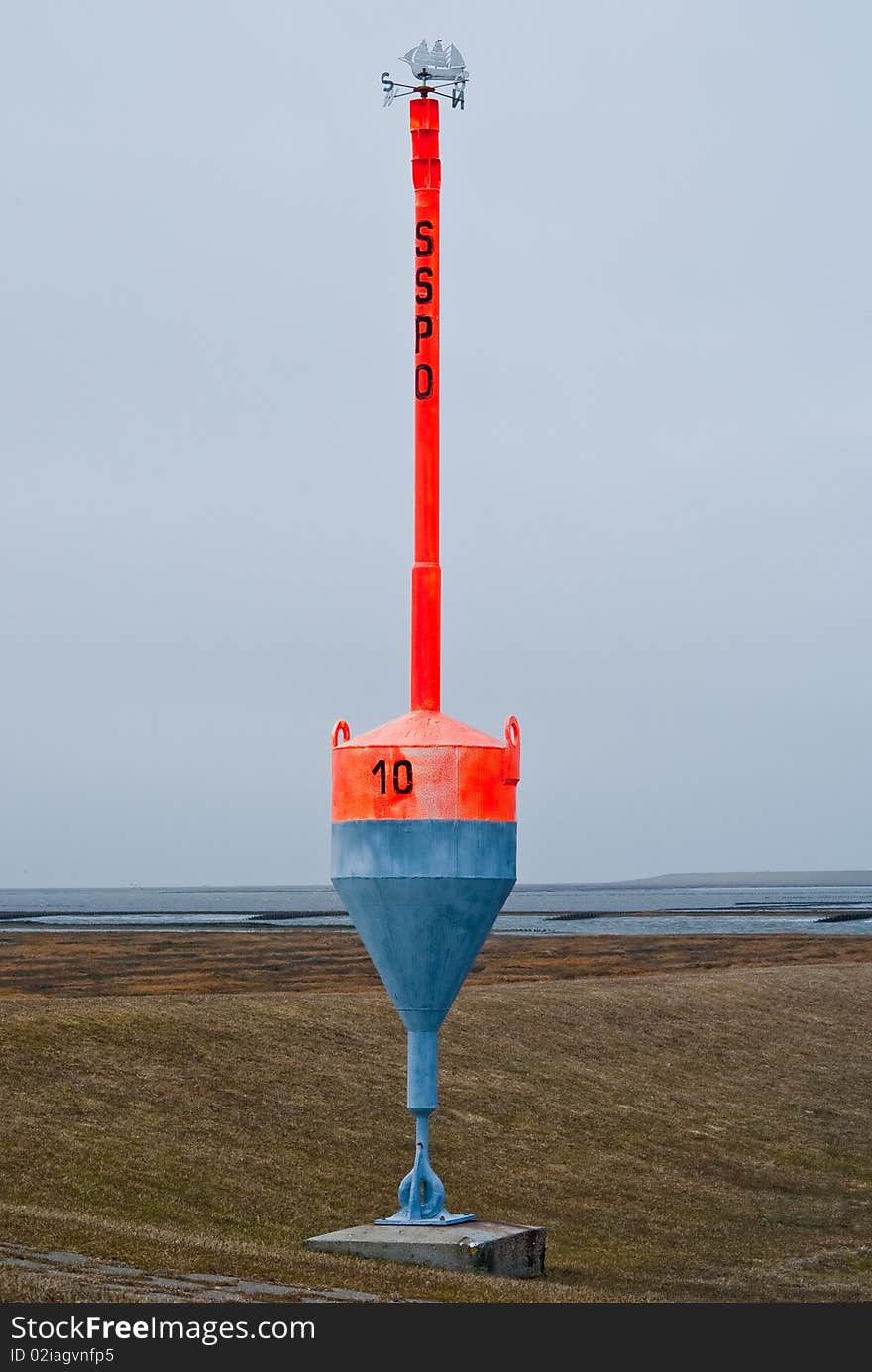 Bright Red Buoy at land in Northern Germany