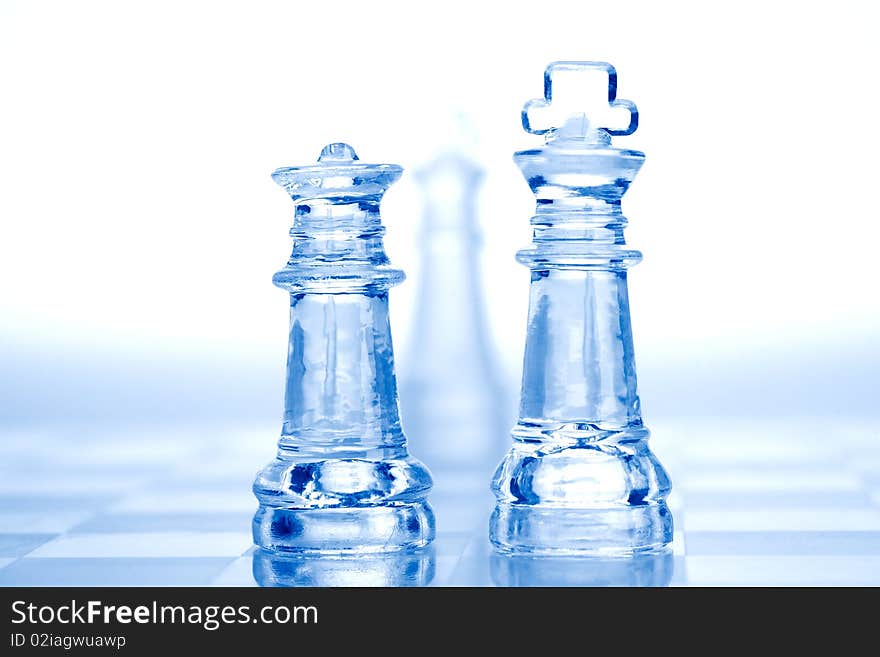 Glass chess pieces with blue light