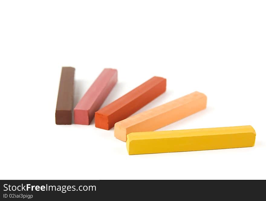 Five colored pastels on a white background