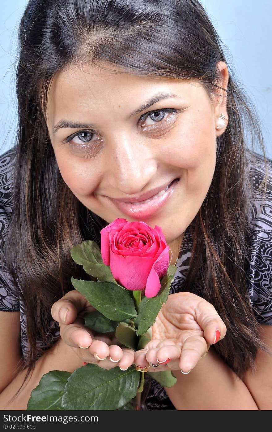 Smiling indian girl with rose flower. Smiling indian girl with rose flower.