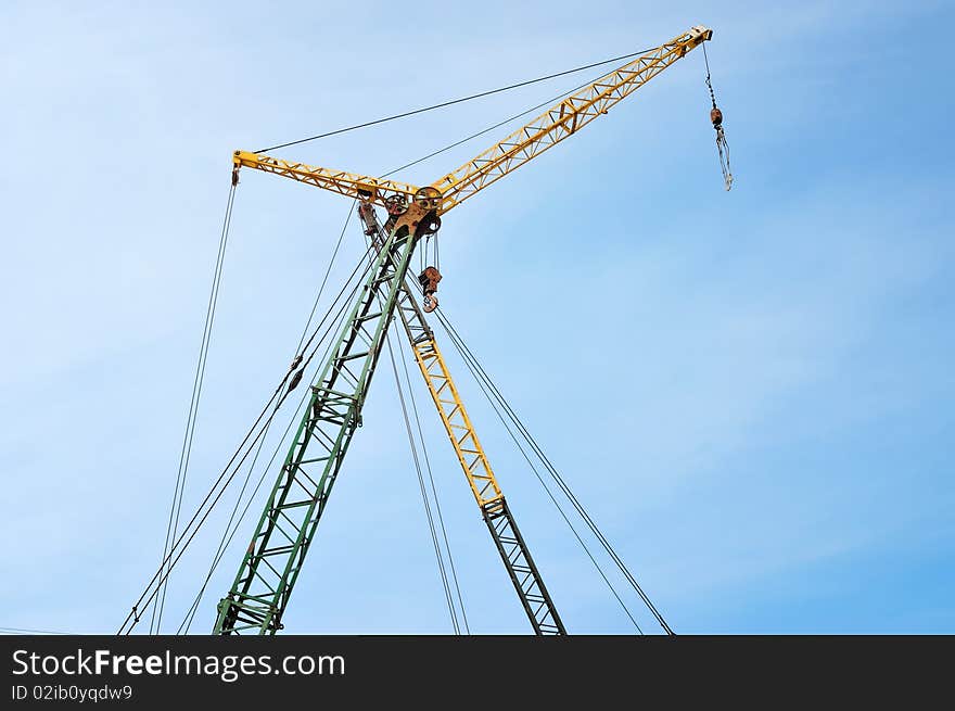 Crane on blue sky background