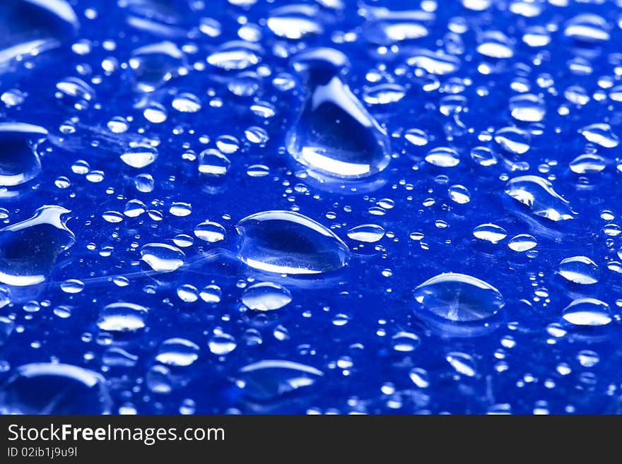 Droplets of water on blue glass