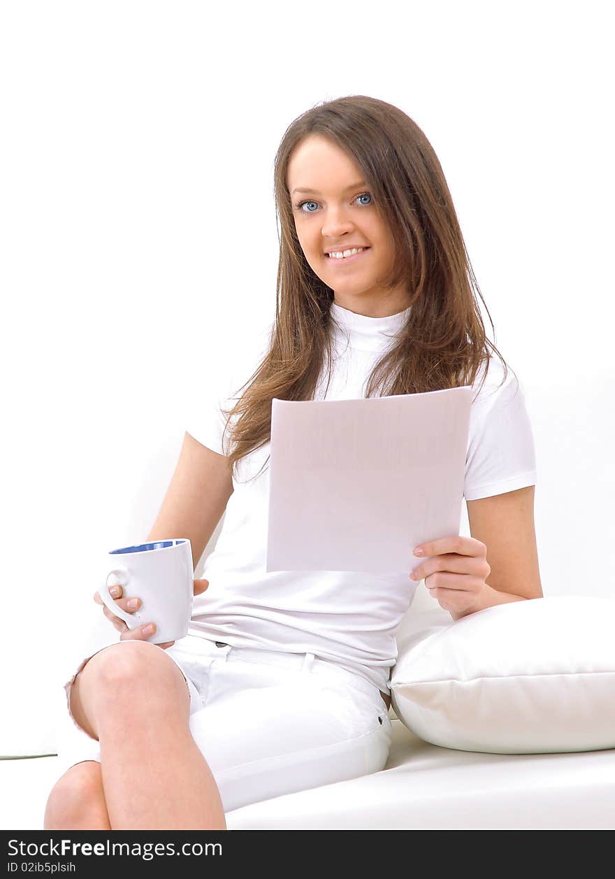 Portrait of happy young woman sitting on sofa, holding coffee cup