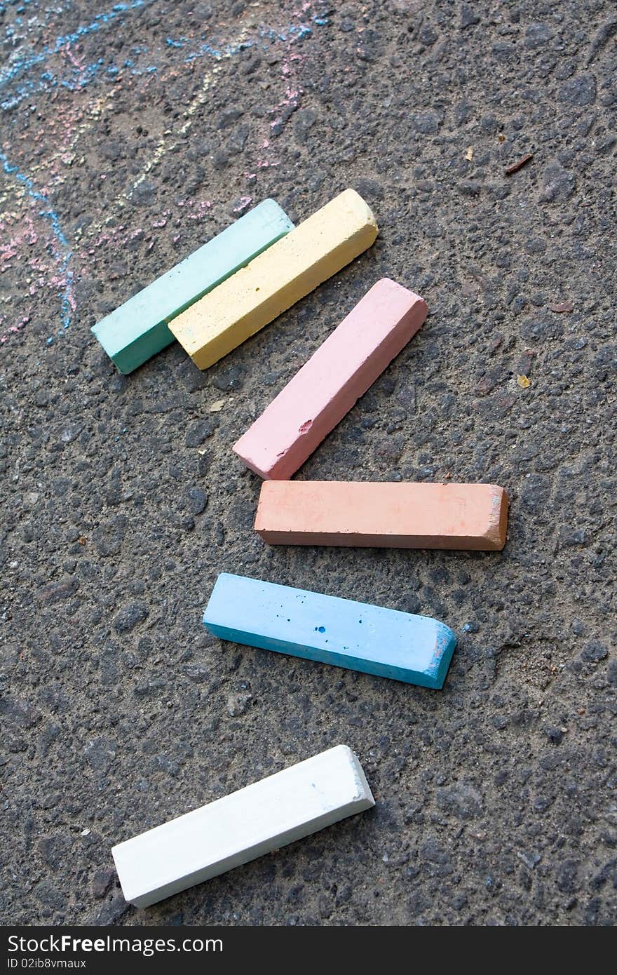 Pieces of chalk on an asphalt