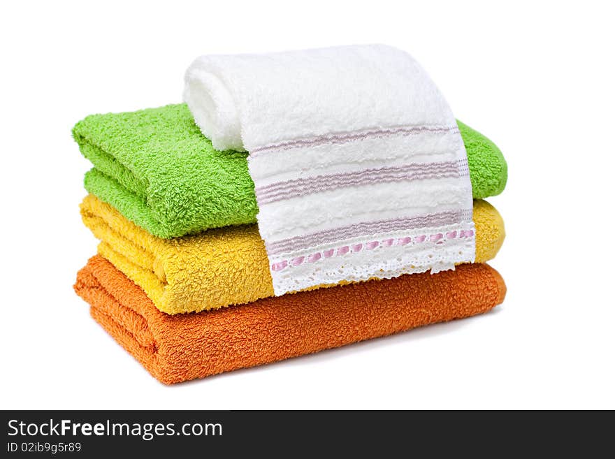 Stacked colorful towels isolated on a white background. Stacked colorful towels isolated on a white background.