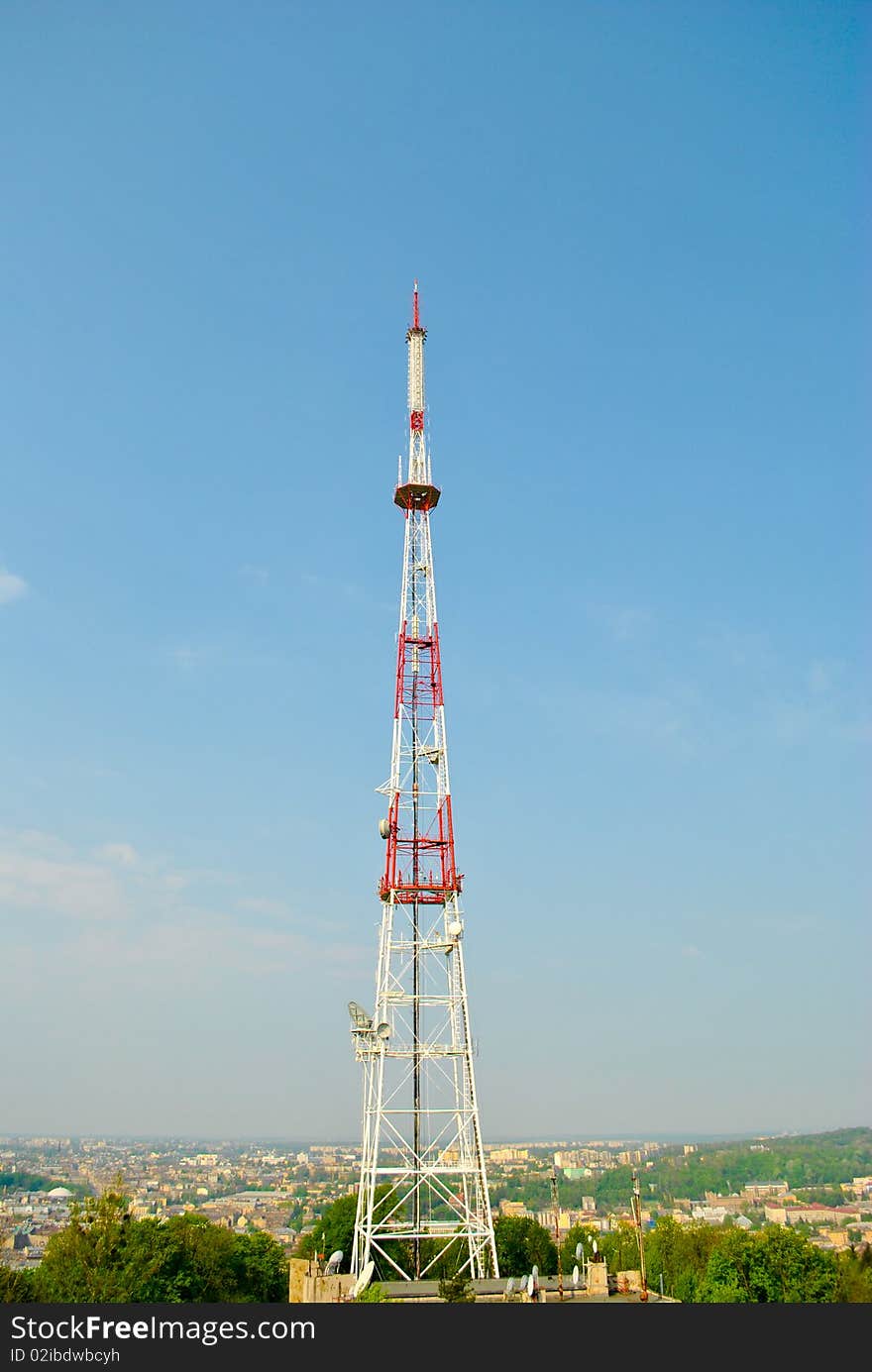 Communication tower over blue sky.