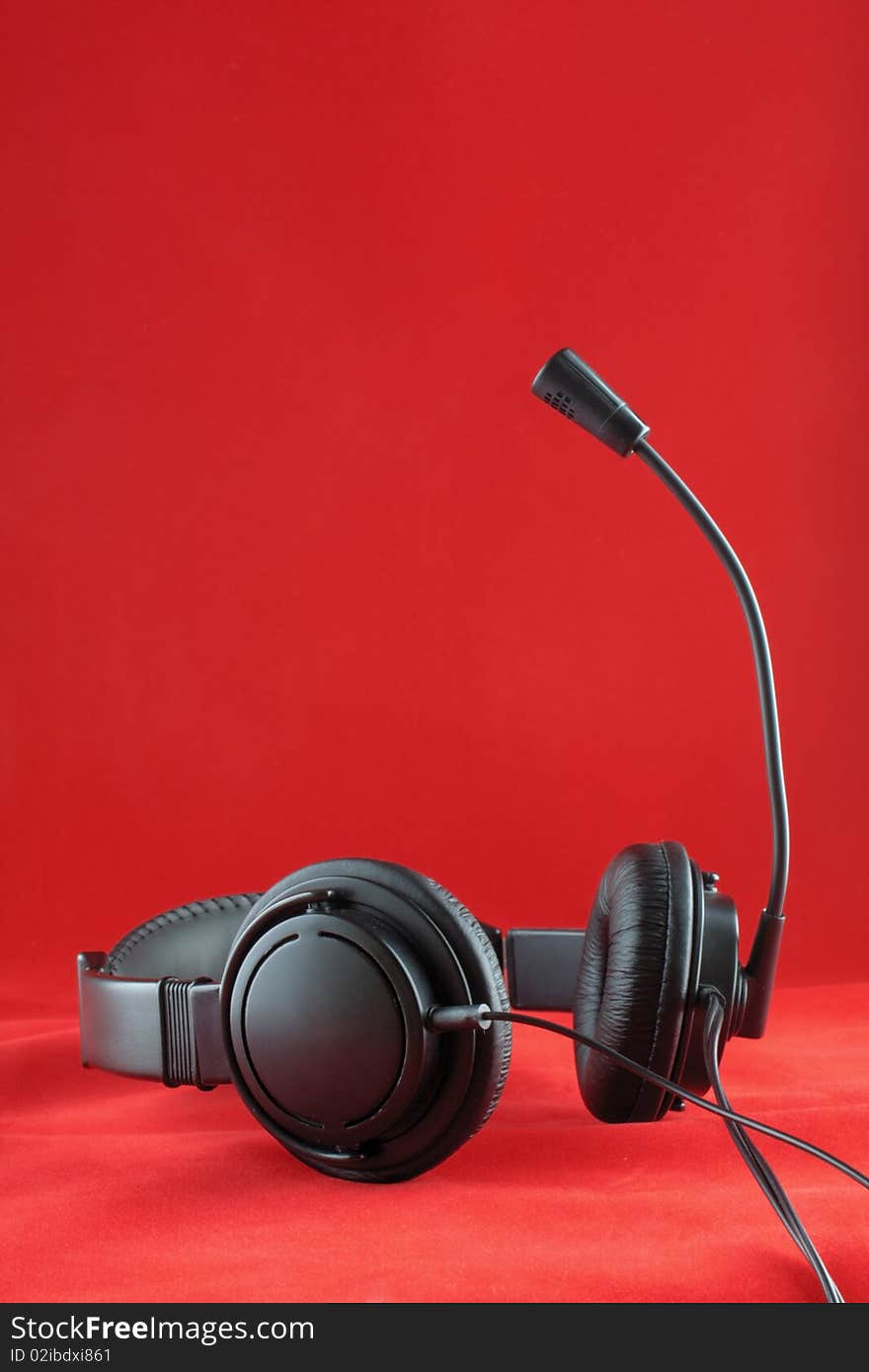 The photo of a stereo headphones on red background. The photo of a stereo headphones on red background