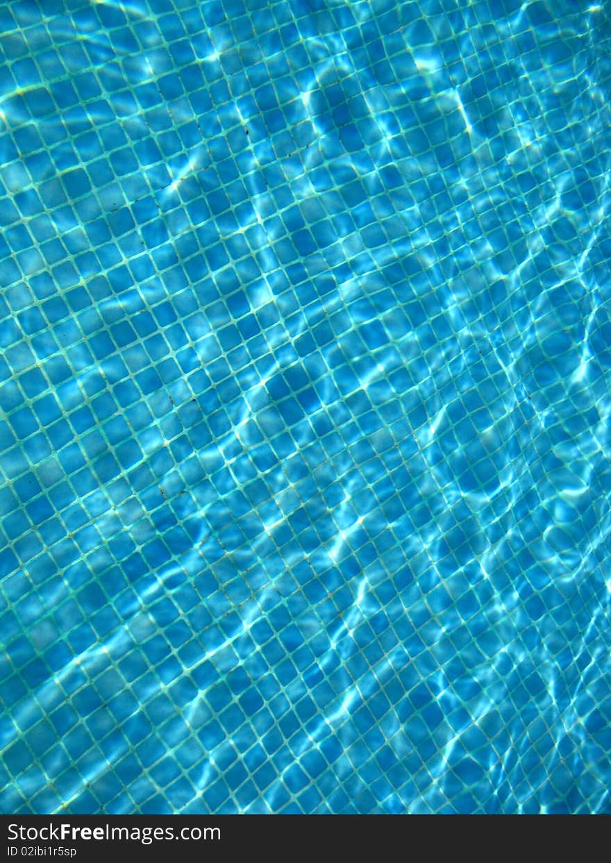 A view on blue clear water in a pool