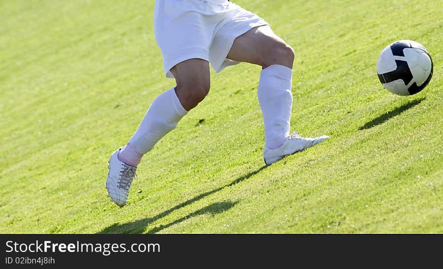 Soccer players running after the ball