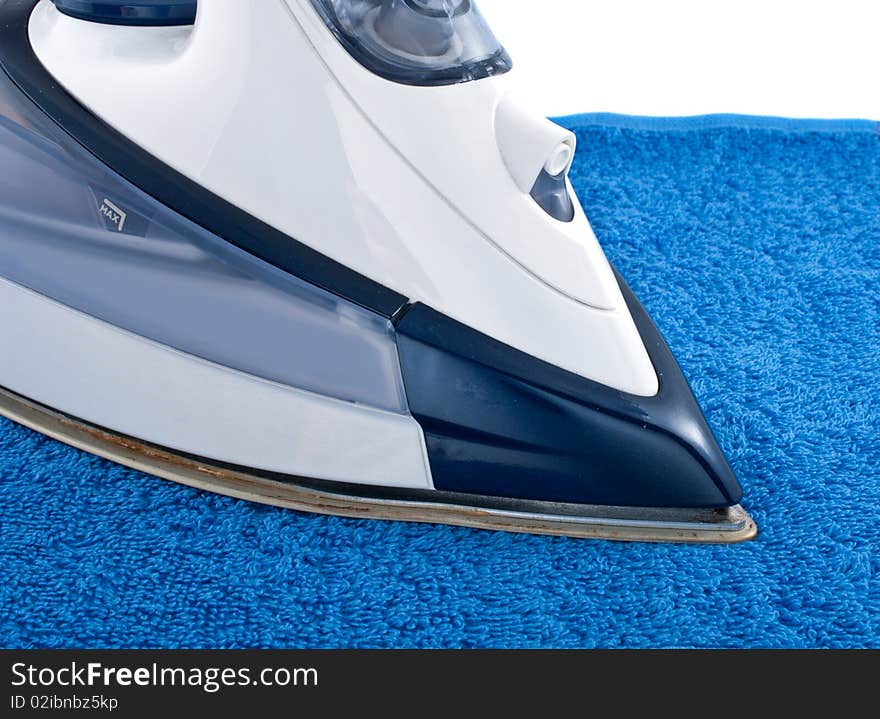 Electric iron on blue towel