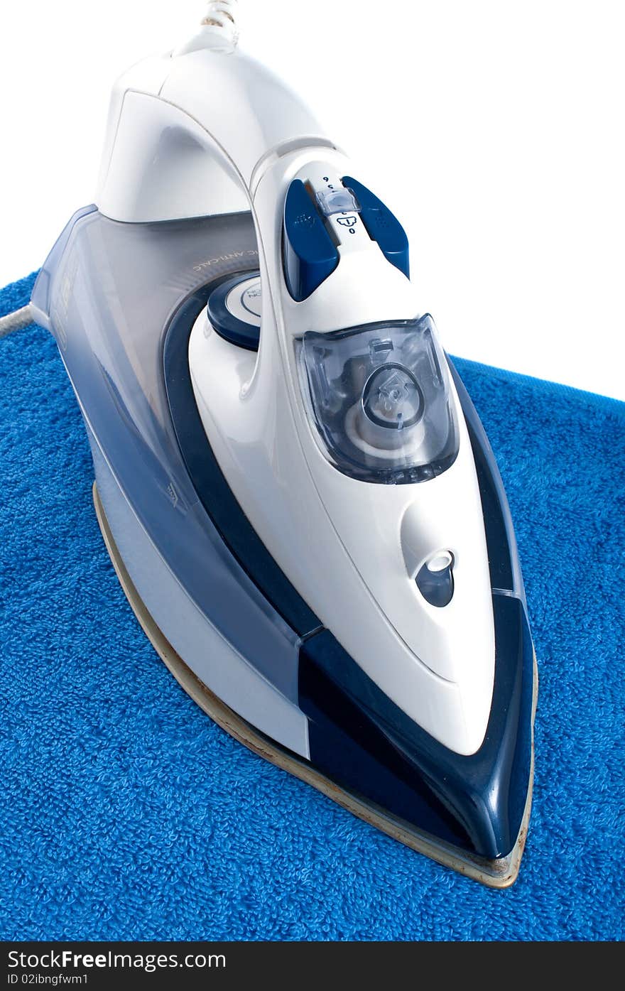 Electric iron on blue towel