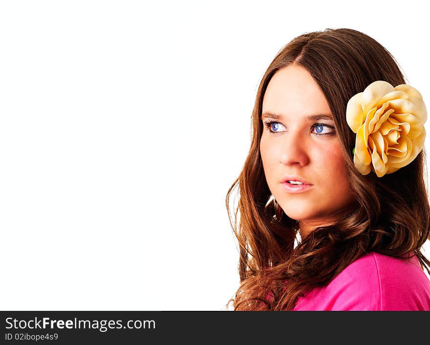 Beautiful girl with flower in hair looking right with place for text